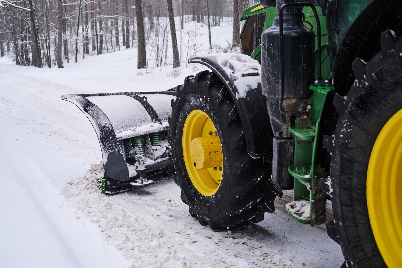 big-special-tractor-is-removing-snow-from-forestal-road_613910-13787